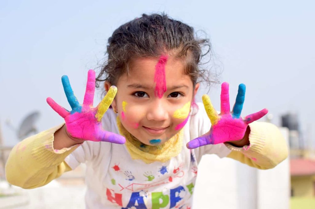 Hands with paint being held up by young girl
